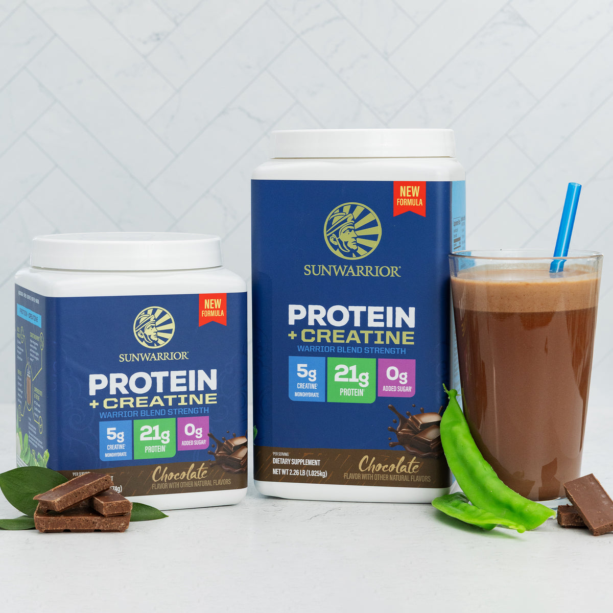 Two containers of Sunwarrior chocolate plant-based protein powder with creatine and a glass of chocolate smoothie