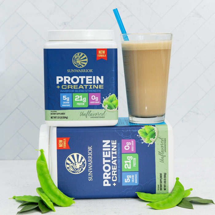 Two containers of Sunwarrior unflavored protein plus creatine powder with a glass of smoothie and green pea pods.