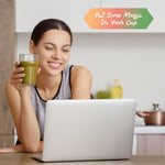 Woman holding a glass of Sunwarrior Yerba Mate in front of a laptop with a kitchen background.