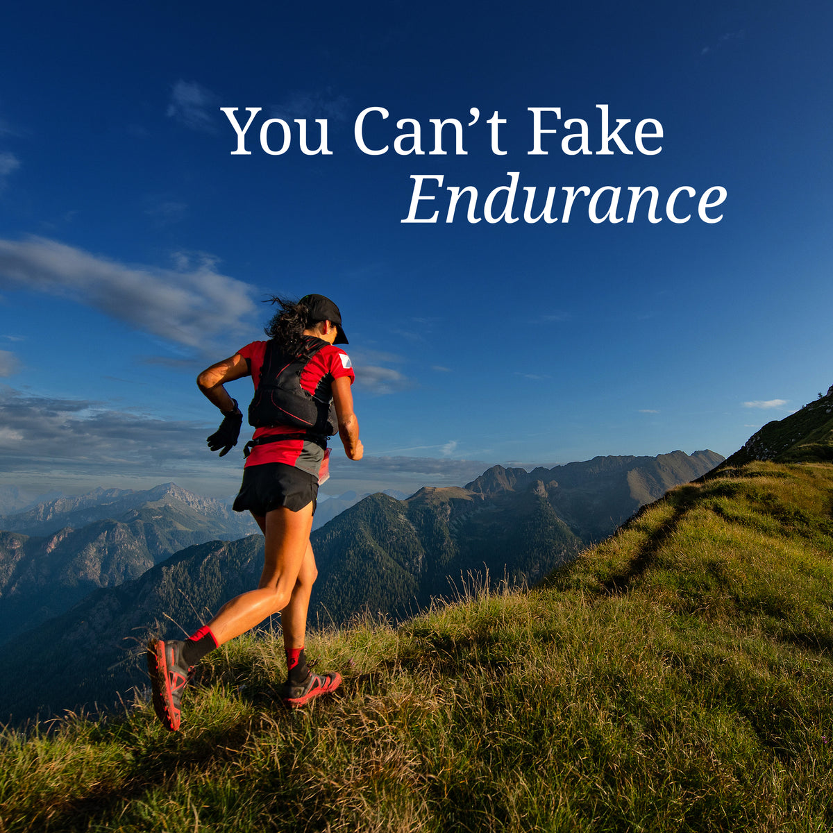 Woman trail running uphill on grassy mountain slope under blue sky with text 
