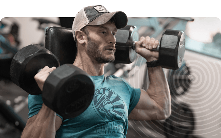 Man lifting dumbbells in a gym setting